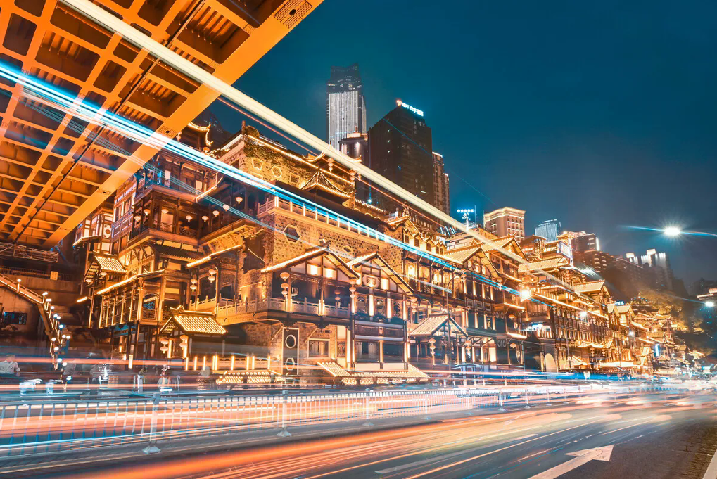 Warm lights and hillside architecture beside the Chongqing river at night